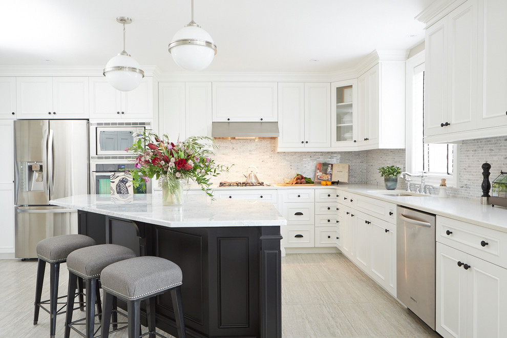 This is an example of a large classic l-shaped kitchen/diner in Toronto with a submerged sink, white cabinets, engineered stone countertops, white splashback, mosaic tiled splashback, stainless steel appliances, porcelain flooring, an island and recessed-panel cabinets.