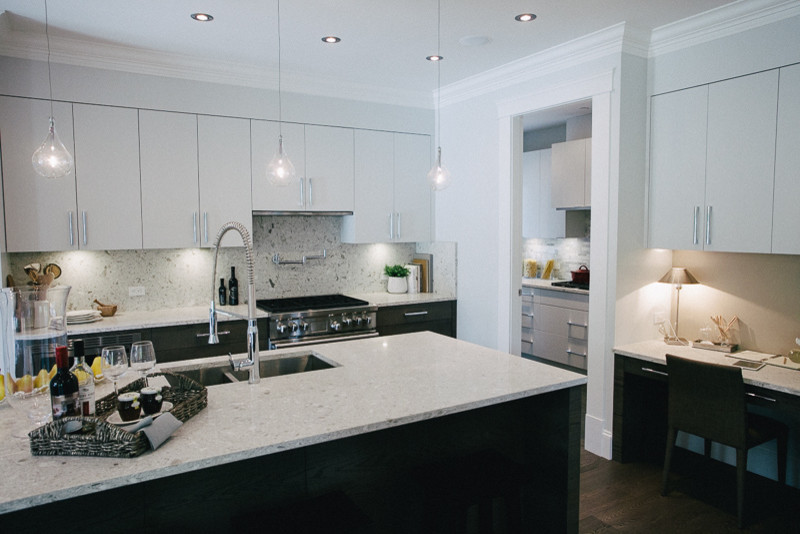 This is an example of a medium sized contemporary kitchen in Vancouver with flat-panel cabinets, white cabinets, granite worktops, multi-coloured splashback, stone slab splashback, stainless steel appliances, dark hardwood flooring and an island.