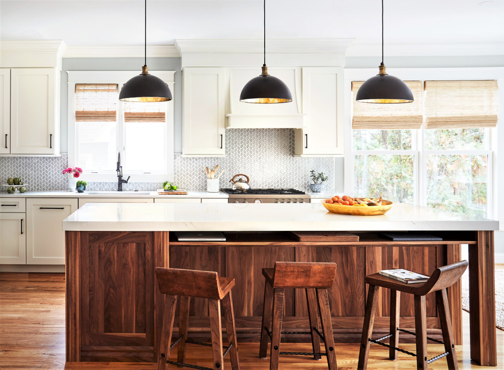 Example of a mid-sized country l-shaped medium tone wood floor open concept kitchen design in DC Metro with an undermount sink, shaker cabinets, medium tone wood cabinets, quartz countertops, gray backsplash, porcelain backsplash, paneled appliances, an island and white countertops