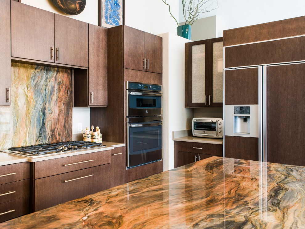 Large classic u-shaped open plan kitchen in Seattle with a submerged sink, flat-panel cabinets, dark wood cabinets, granite worktops, beige splashback, stainless steel appliances, porcelain flooring and an island.
