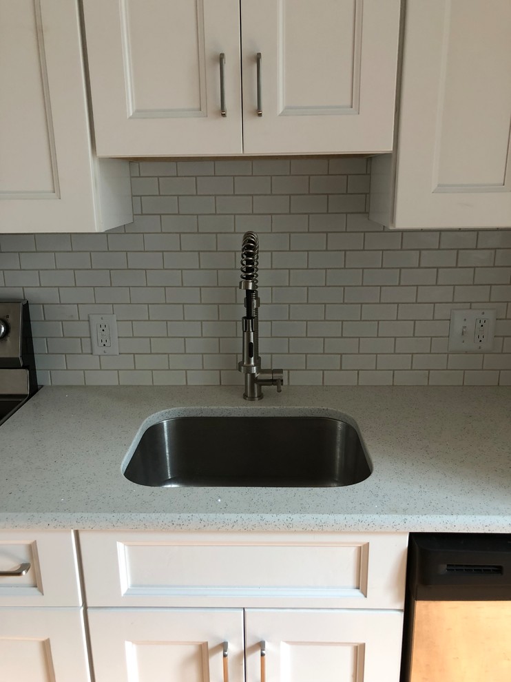 Small trendy single-wall bamboo floor and brown floor eat-in kitchen photo in Philadelphia with an undermount sink, shaker cabinets, white cabinets, quartzite countertops, white backsplash, subway tile backsplash, stainless steel appliances, no island and white countertops