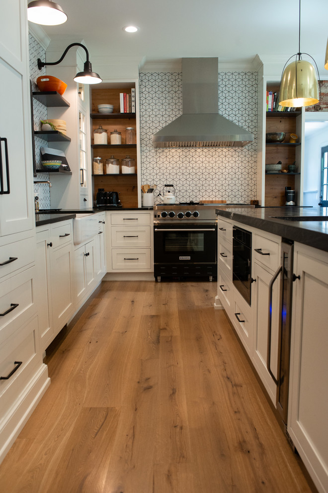 Example of an eclectic l-shaped kitchen design in Philadelphia with soapstone countertops and black countertops