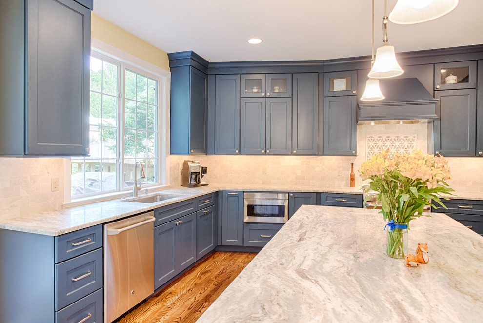 Enclosed kitchen - large contemporary l-shaped light wood floor enclosed kitchen idea in Philadelphia with an undermount sink, flat-panel cabinets, blue cabinets, quartzite countertops, white backsplash, subway tile backsplash, stainless steel appliances and an island