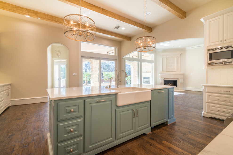 Inspiration for a huge timeless l-shaped medium tone wood floor eat-in kitchen remodel in Dallas with a farmhouse sink, raised-panel cabinets, white cabinets, marble countertops, white backsplash, porcelain backsplash, paneled appliances and an island