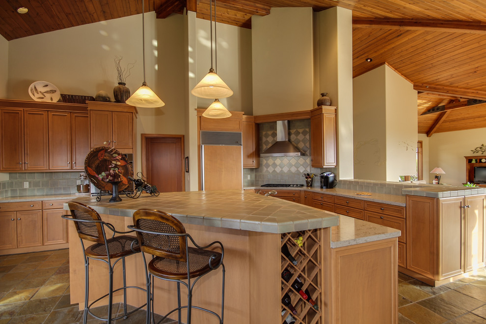 Inspiration for a classic kitchen in Seattle with recessed-panel cabinets, medium wood cabinets, tile countertops, grey splashback and integrated appliances.