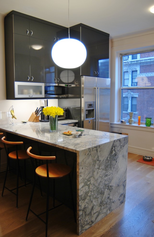 Foto di una cucina design con ante lisce, ante grigie e elettrodomestici in acciaio inossidabile