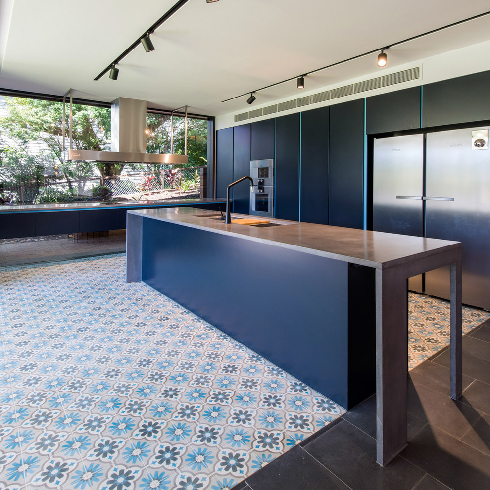 Inspiration for a modern ceramic tile kitchen remodel in Brisbane with an undermount sink, flat-panel cabinets, blue cabinets, concrete countertops, glass sheet backsplash, stainless steel appliances and an island