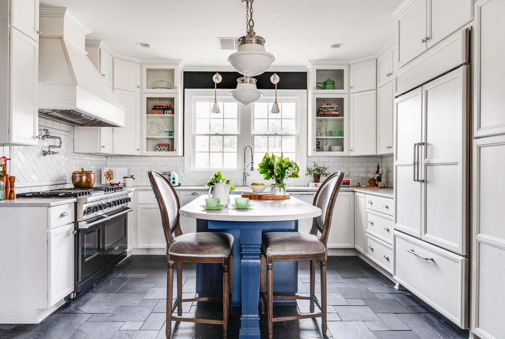 Large transitional u-shaped slate floor and black floor eat-in kitchen photo in Nashville with a farmhouse sink, recessed-panel cabinets, white cabinets, quartz countertops, white backsplash, subway tile backsplash, black appliances, an island and white countertops