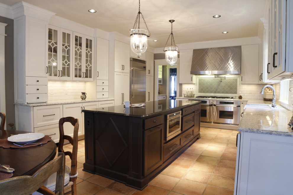 Inspiration for a large transitional terra-cotta tile eat-in kitchen remodel in Nashville with a farmhouse sink, white cabinets, quartz countertops, white backsplash, subway tile backsplash, stainless steel appliances, an island and recessed-panel cabinets