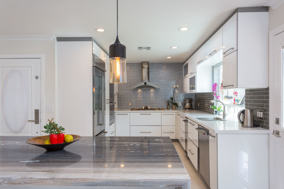 Example of a large trendy u-shaped open concept kitchen design in Los Angeles with white cabinets, a double-bowl sink, flat-panel cabinets, quartzite countertops, gray backsplash, subway tile backsplash, stainless steel appliances and an island