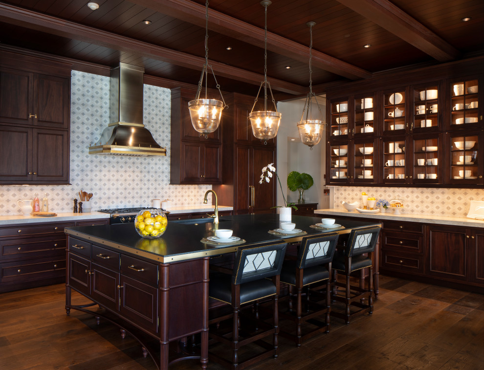This is an example of a large world-inspired l-shaped kitchen/diner in Tampa with a submerged sink, shaker cabinets, dark wood cabinets, quartz worktops, multi-coloured splashback, ceramic splashback, black appliances, dark hardwood flooring, an island, brown floors, black worktops and exposed beams.