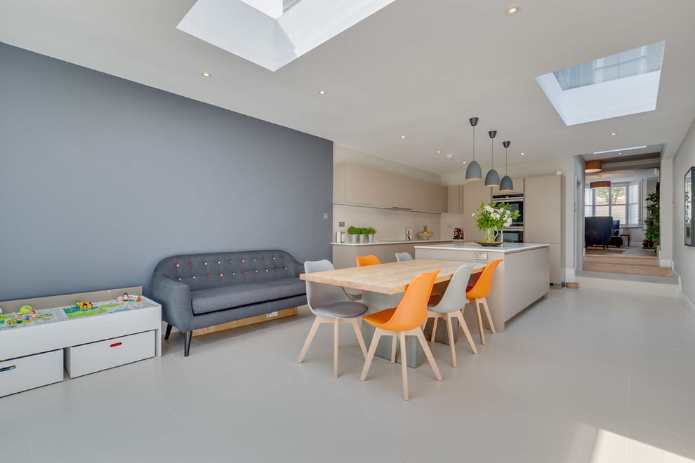 Design ideas for a large modern grey and cream single-wall open plan kitchen in London with flat-panel cabinets, granite worktops, an island and white worktops.