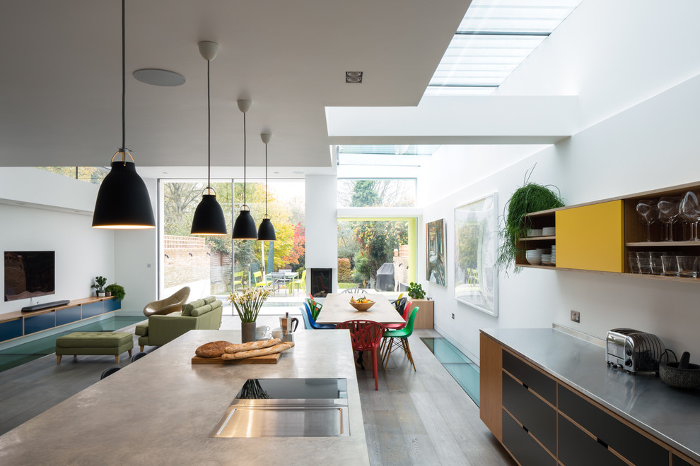 Offene Moderne Küche in L-Form mit Betonarbeitsplatte, Küchengeräten aus Edelstahl und Kücheninsel in London