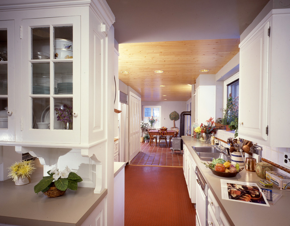 Transitional galley enclosed kitchen photo in Philadelphia with a double-bowl sink, flat-panel cabinets, yellow cabinets, yellow backsplash, ceramic backsplash and white appliances