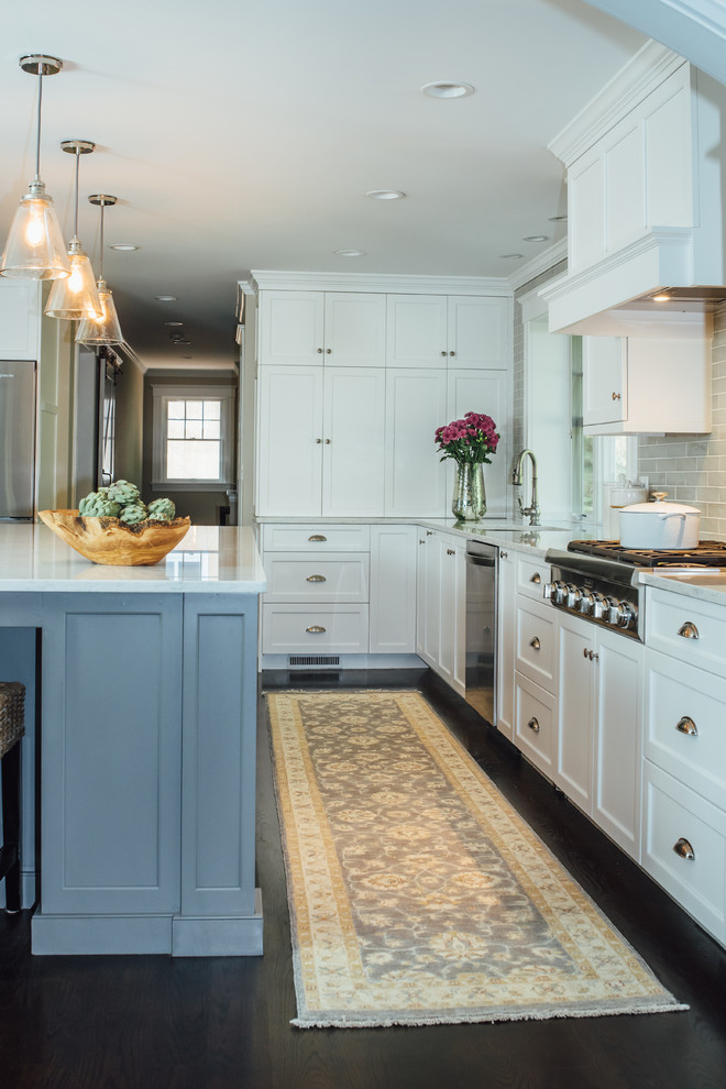 Photo of a large classic l-shaped open plan kitchen in Boston with a built-in sink, shaker cabinets, grey cabinets, engineered stone countertops, grey splashback, ceramic splashback, stainless steel appliances, dark hardwood flooring, an island and brown floors.