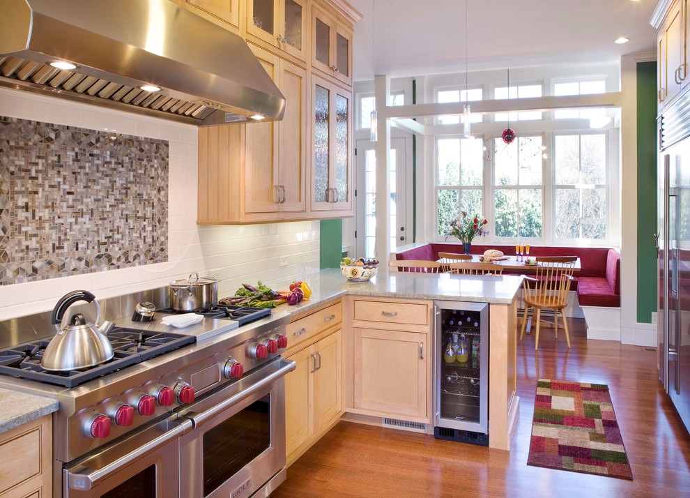 Example of a small ornate light wood floor and beige floor eat-in kitchen design in Boston with stainless steel appliances, shaker cabinets, light wood cabinets, granite countertops, white backsplash, subway tile backsplash, a peninsula and gray countertops