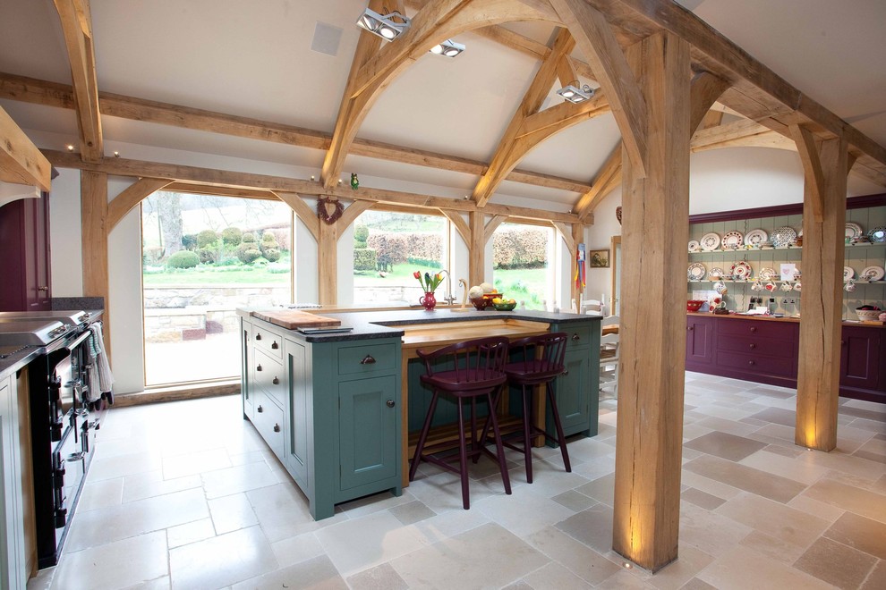 Design ideas for a rural kitchen in Other with shaker cabinets, an island, beige floors and black worktops.