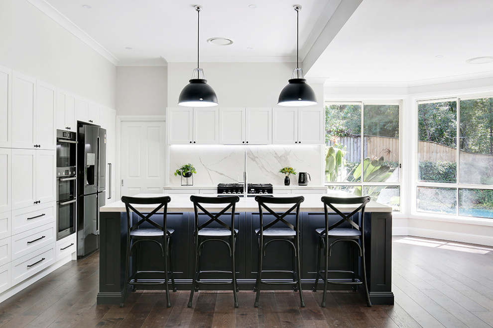Inspiration for a large classic l-shaped open plan kitchen in Sydney with shaker cabinets, black cabinets, tile countertops, multi-coloured splashback, ceramic splashback, medium hardwood flooring, an island, brown floors, a single-bowl sink, black appliances and white worktops.