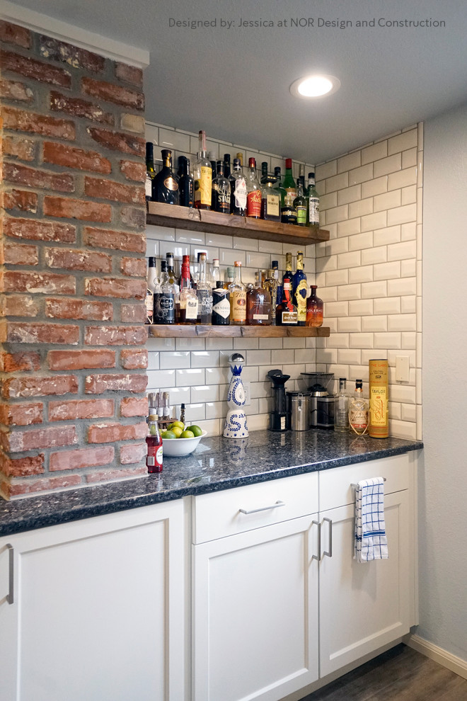 Inspiration for a medium sized contemporary l-shaped home bar in Seattle with a submerged sink, shaker cabinets, white cabinets, granite worktops, white splashback, ceramic splashback, vinyl flooring, grey floors and blue worktops.