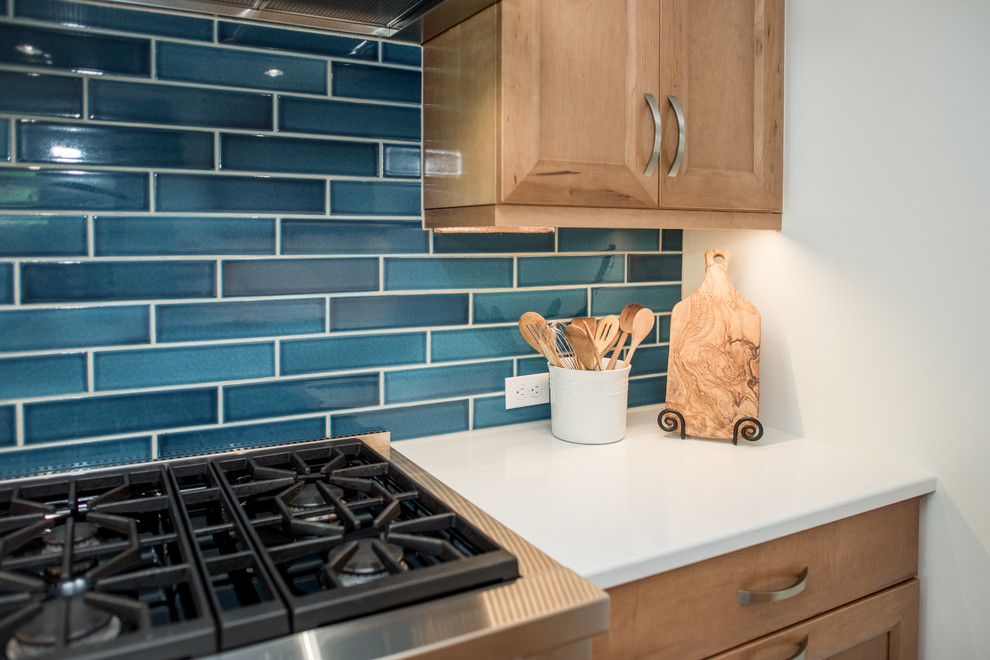 Inspiration for a transitional galley light wood floor and beige floor kitchen remodel in Seattle with recessed-panel cabinets, light wood cabinets, quartz countertops, blue backsplash, porcelain backsplash, stainless steel appliances, no island and white countertops