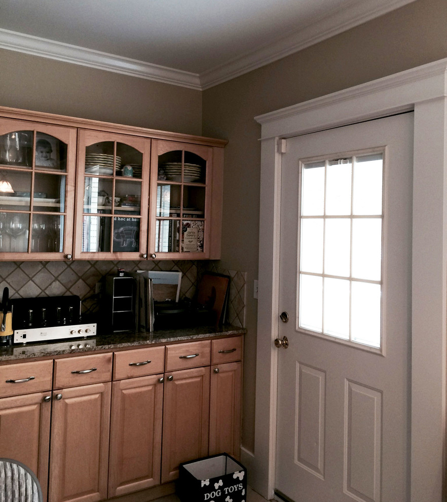 Foto di una cucina abitabile design di medie dimensioni con ante di vetro, ante in legno scuro, top in granito, paraspruzzi marrone, paraspruzzi con piastrelle in ceramica e elettrodomestici in acciaio inossidabile