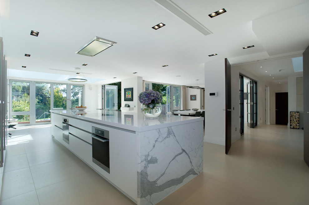 Inspiration for a large contemporary kitchen in Sussex with marble worktops and limestone flooring.