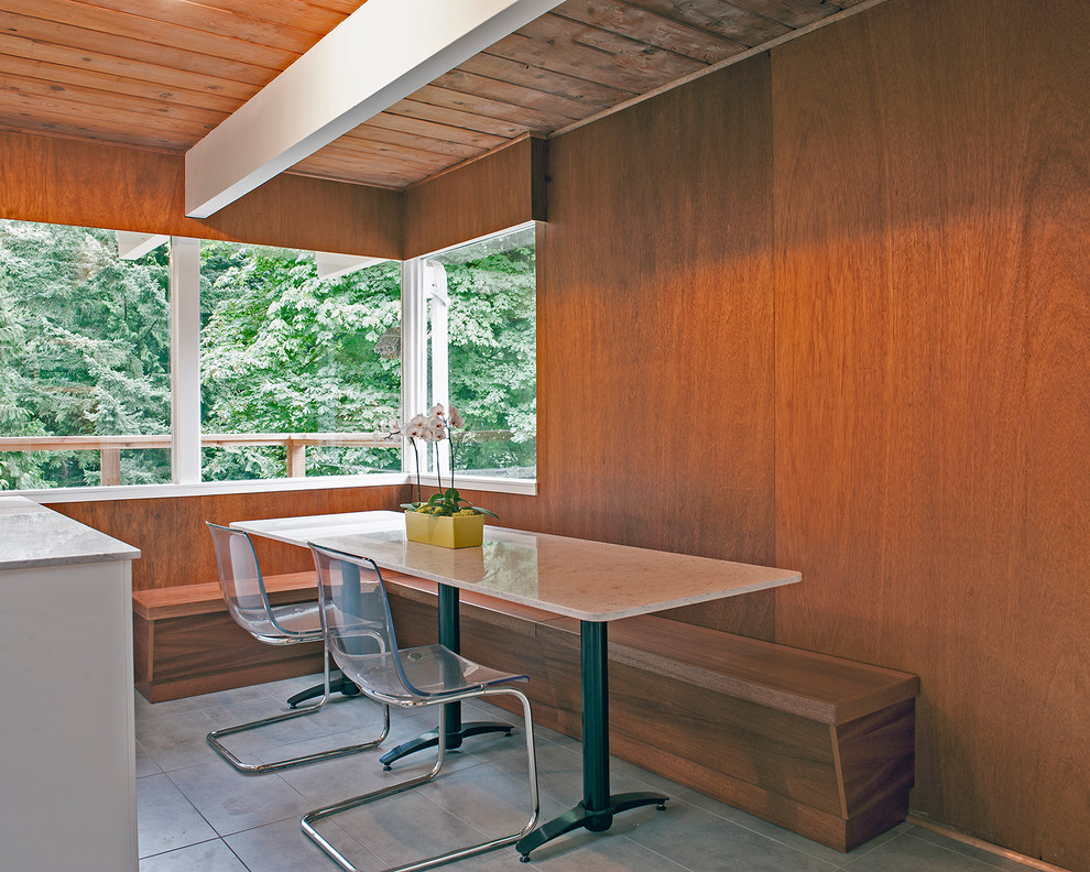 Mid-sized 1960s u-shaped ceramic tile eat-in kitchen photo in Vancouver with a drop-in sink, flat-panel cabinets, white cabinets, quartz countertops, black backsplash, subway tile backsplash and stainless steel appliances