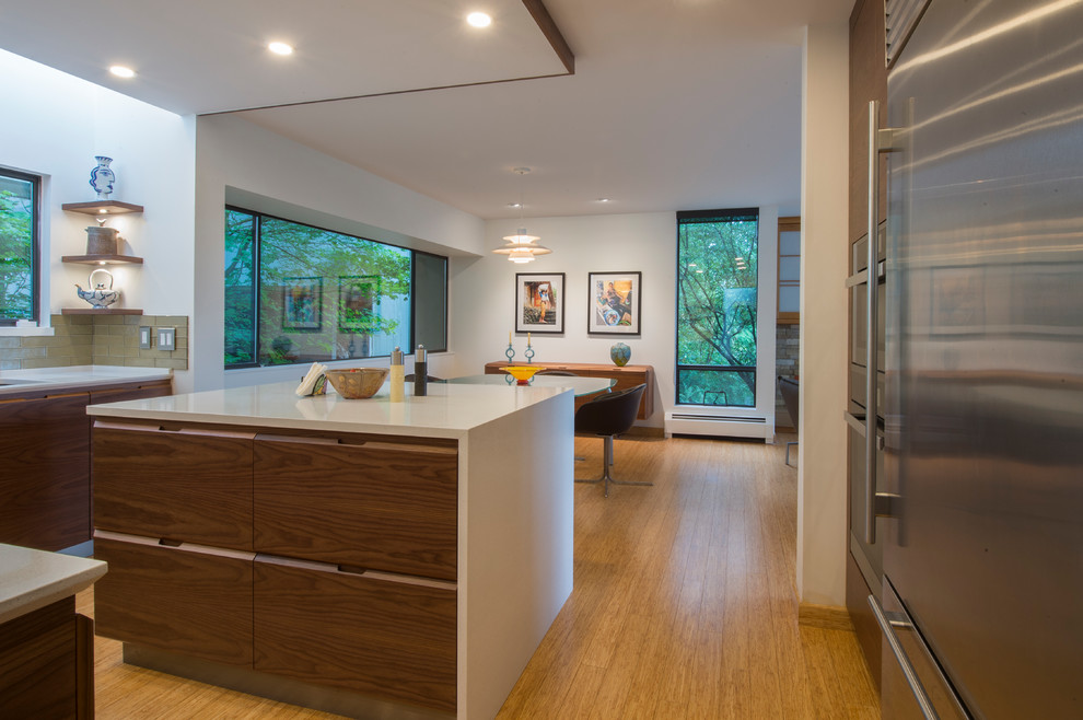 Inspiration for a mid-sized modern u-shaped bamboo floor and beige floor eat-in kitchen remodel in Vancouver with an undermount sink, flat-panel cabinets, dark wood cabinets, quartz countertops, green backsplash, glass tile backsplash, stainless steel appliances and an island