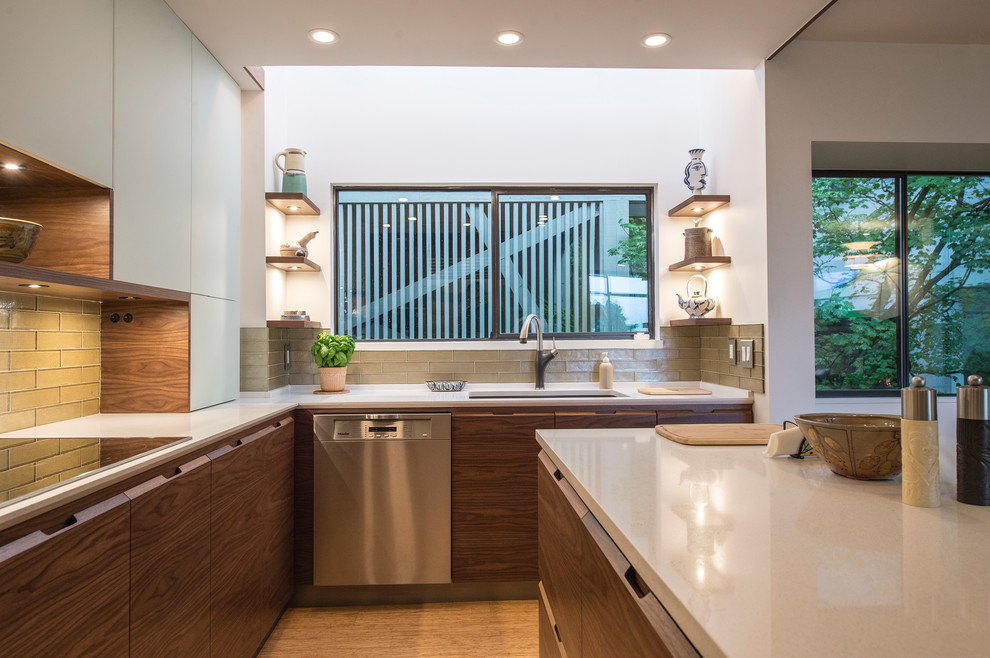 Example of a mid-sized minimalist u-shaped bamboo floor and beige floor eat-in kitchen design in Vancouver with an undermount sink, flat-panel cabinets, dark wood cabinets, quartz countertops, green backsplash, glass tile backsplash, stainless steel appliances and an island
