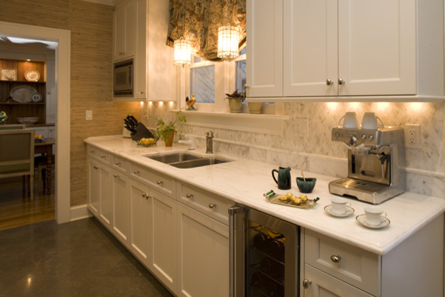 Example of a small classic galley limestone floor enclosed kitchen design in New York with an integrated sink, beaded inset cabinets, white cabinets, gray backsplash, stainless steel appliances and no island