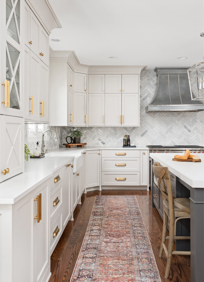 Large transitional u-shaped dark wood floor and brown floor open concept kitchen photo in Chicago with a farmhouse sink, recessed-panel cabinets, gray cabinets, quartz countertops, gray backsplash, marble backsplash, stainless steel appliances, an island and white countertops
