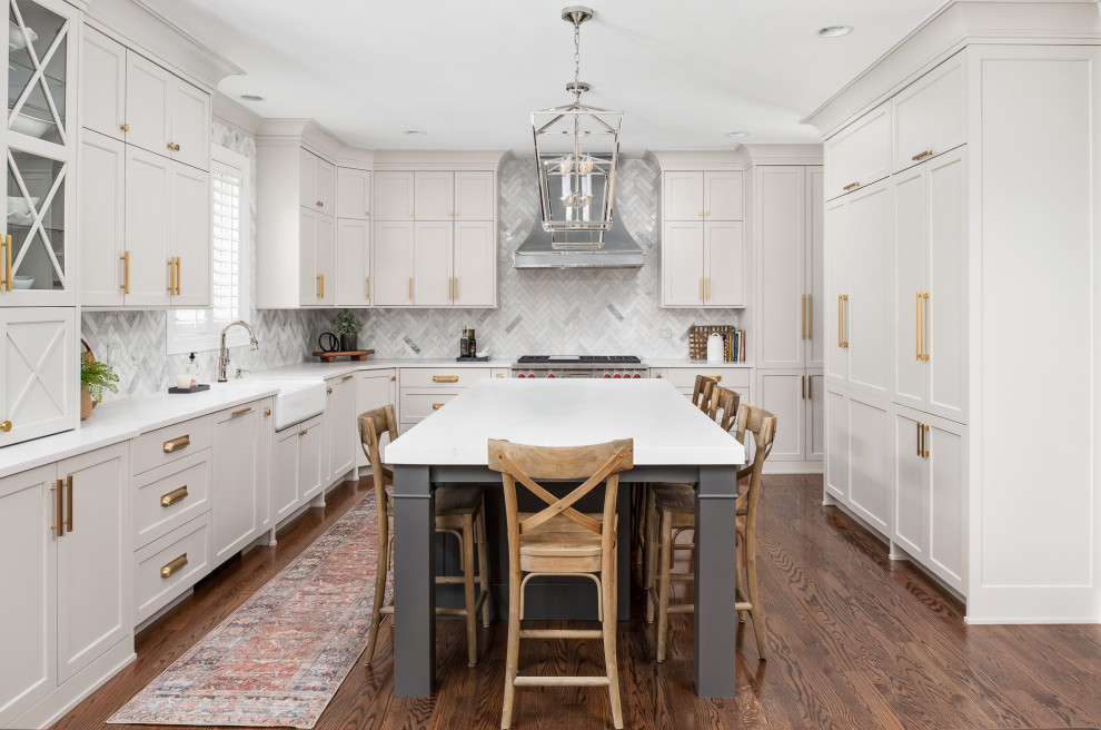 Example of a large transitional u-shaped dark wood floor and brown floor open concept kitchen design in Chicago with a farmhouse sink, recessed-panel cabinets, gray cabinets, quartz countertops, gray backsplash, marble backsplash, stainless steel appliances, an island and white countertops