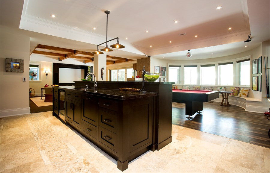 Example of a large beach style galley dark wood floor kitchen design in Newark with a drop-in sink, recessed-panel cabinets, dark wood cabinets, granite countertops, stainless steel appliances and an island