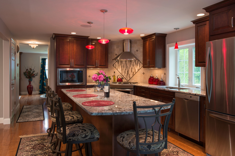 Inspiration for a large transitional single-wall light wood floor eat-in kitchen remodel in Boston with a drop-in sink, dark wood cabinets, granite countertops, multicolored backsplash, ceramic backsplash, stainless steel appliances and an island