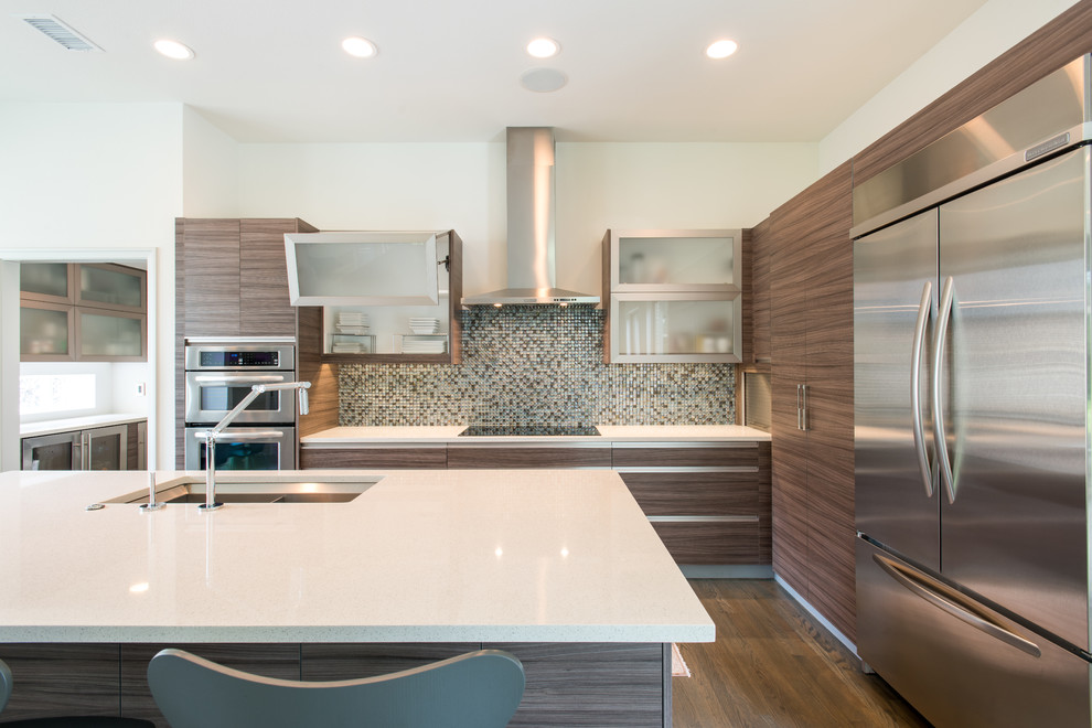 Mid-sized trendy l-shaped light wood floor enclosed kitchen photo in Dallas with an undermount sink, flat-panel cabinets, medium tone wood cabinets, quartz countertops, multicolored backsplash, mosaic tile backsplash, stainless steel appliances and an island