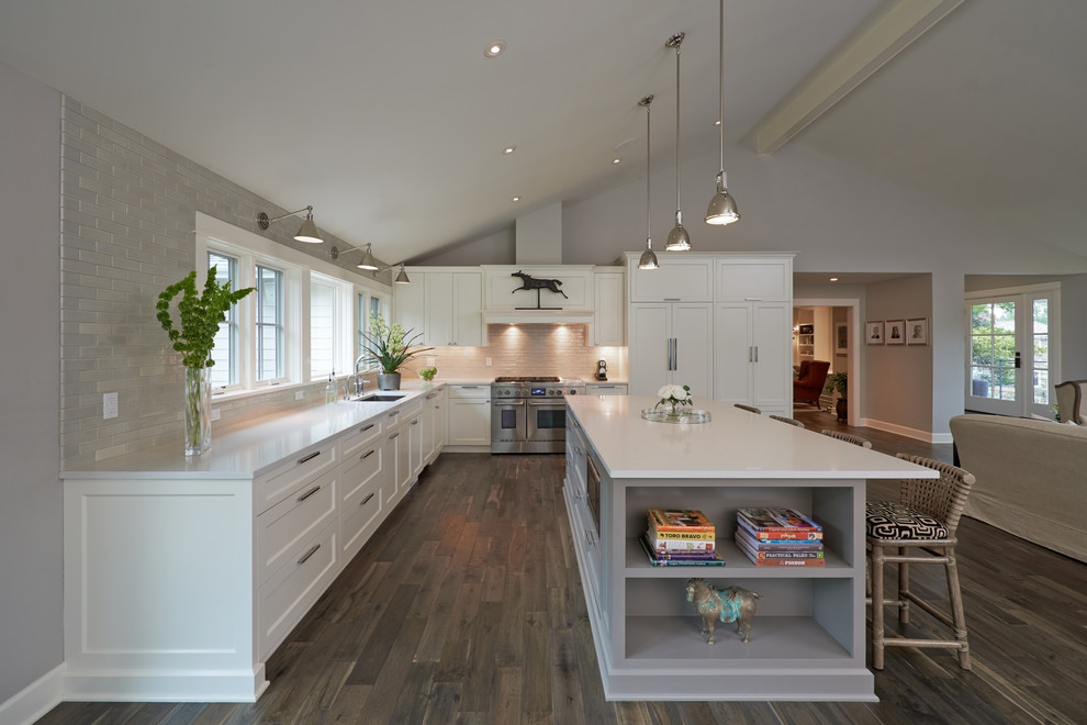 Design ideas for a large contemporary l-shaped kitchen/diner in Portland with a submerged sink, recessed-panel cabinets, white cabinets, quartz worktops, grey splashback, metro tiled splashback, integrated appliances, medium hardwood flooring and an island.