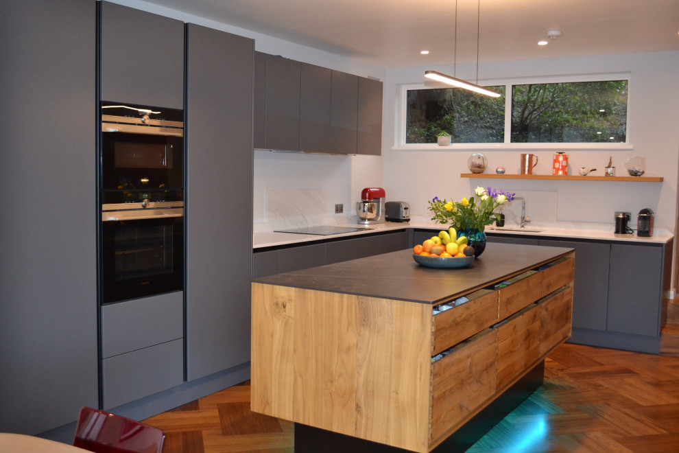 Medium sized scandinavian kitchen in Surrey with medium hardwood flooring, an island and purple floors.