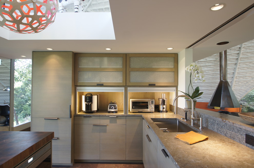 Inspiration for a medium sized modern u-shaped enclosed kitchen in Austin with a single-bowl sink, flat-panel cabinets, grey cabinets, limestone worktops, multi-coloured splashback, mosaic tiled splashback, integrated appliances, cork flooring and an island.