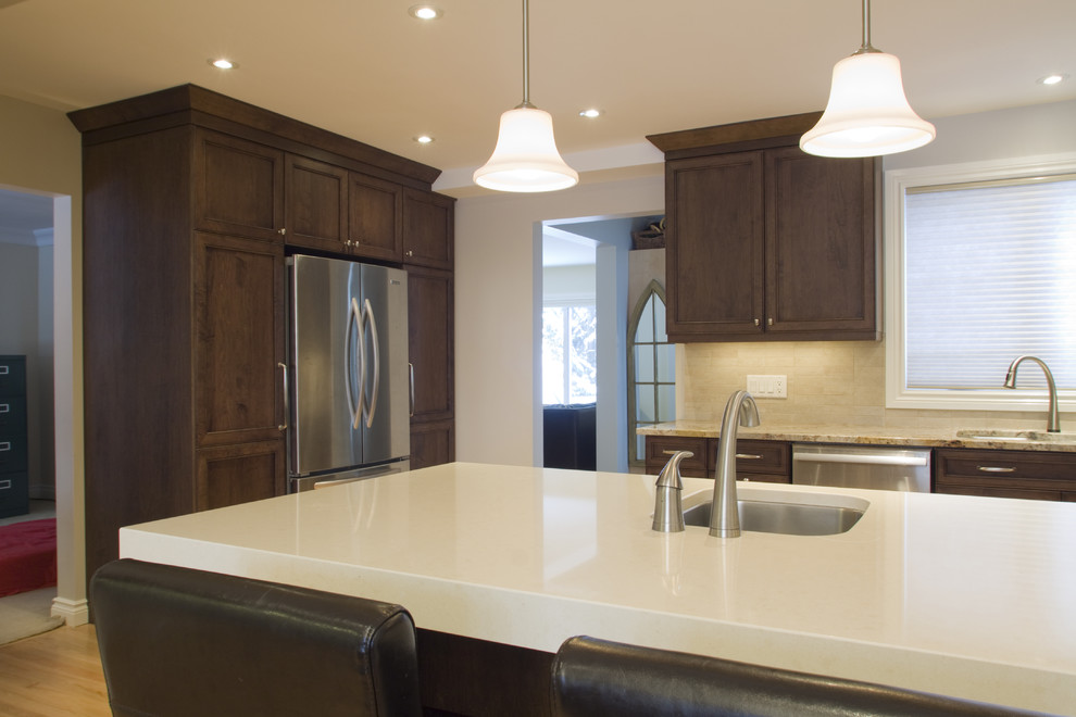 Eat-in kitchen - mid-sized contemporary u-shaped light wood floor eat-in kitchen idea in Ottawa with a single-bowl sink, recessed-panel cabinets, dark wood cabinets, quartz countertops, beige backsplash, stone tile backsplash, stainless steel appliances and a peninsula