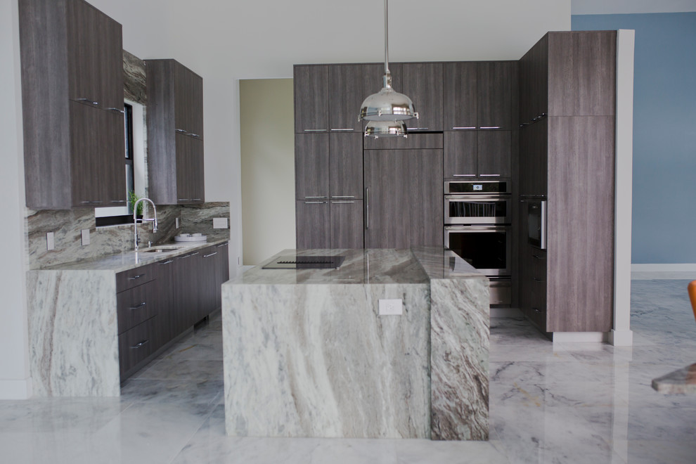 This is an example of a large contemporary u-shaped open plan kitchen in Miami with a submerged sink, flat-panel cabinets, brown cabinets, granite worktops, multi-coloured splashback, stone slab splashback, stainless steel appliances, marble flooring, multiple islands, white floors and grey worktops.