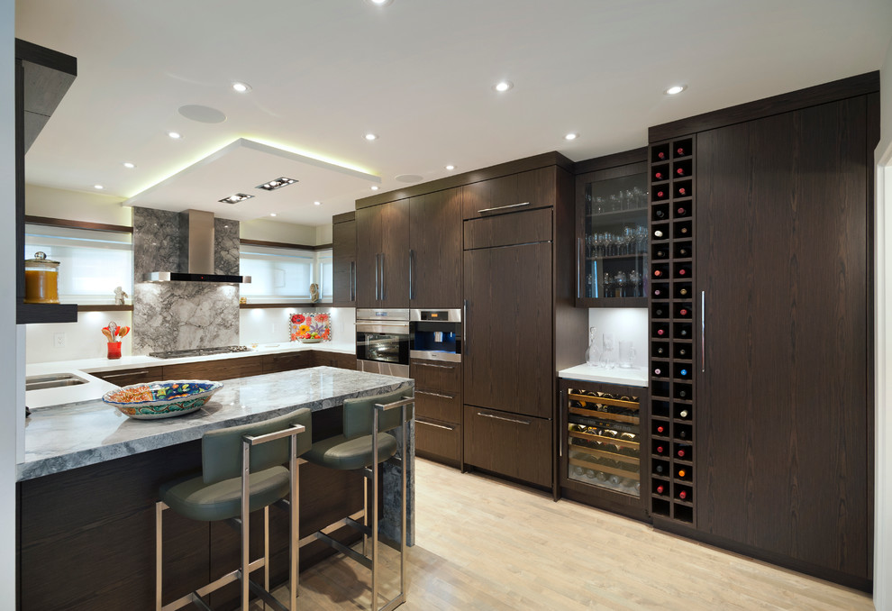 Example of a trendy u-shaped eat-in kitchen design in Vancouver with an undermount sink, flat-panel cabinets and dark wood cabinets