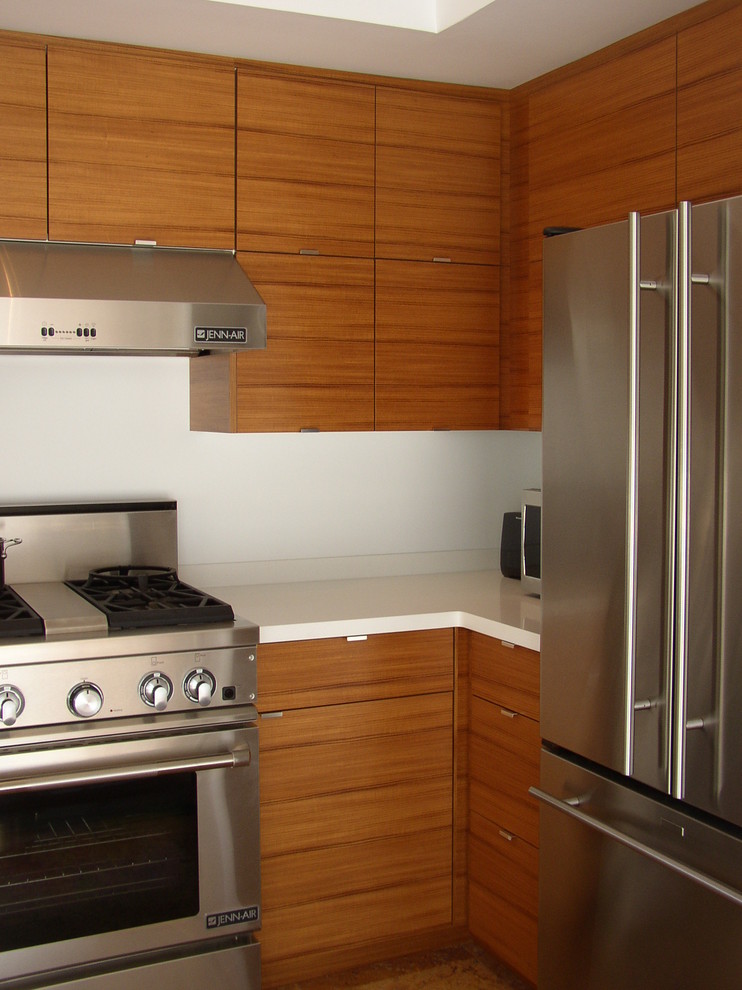 This is an example of a small modern u-shaped kitchen/diner in Minneapolis with a submerged sink, flat-panel cabinets, medium wood cabinets, quartz worktops, white splashback, stone slab splashback, stainless steel appliances and no island.