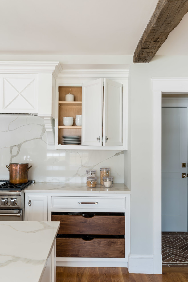 ボストンにあるトランジショナルスタイルのおしゃれなキッチン (落し込みパネル扉のキャビネット、白いキャビネット、クオーツストーンカウンター、白いキッチンパネル、無垢フローリング、茶色い床、白いキッチンカウンター) の写真