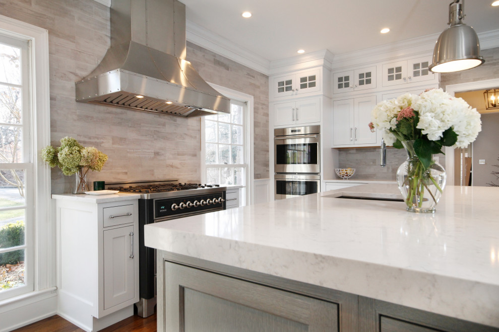 This is an example of a large classic kitchen in New York with beaded cabinets, distressed cabinets, engineered stone countertops, grey splashback, cement tile splashback, stainless steel appliances and white worktops.
