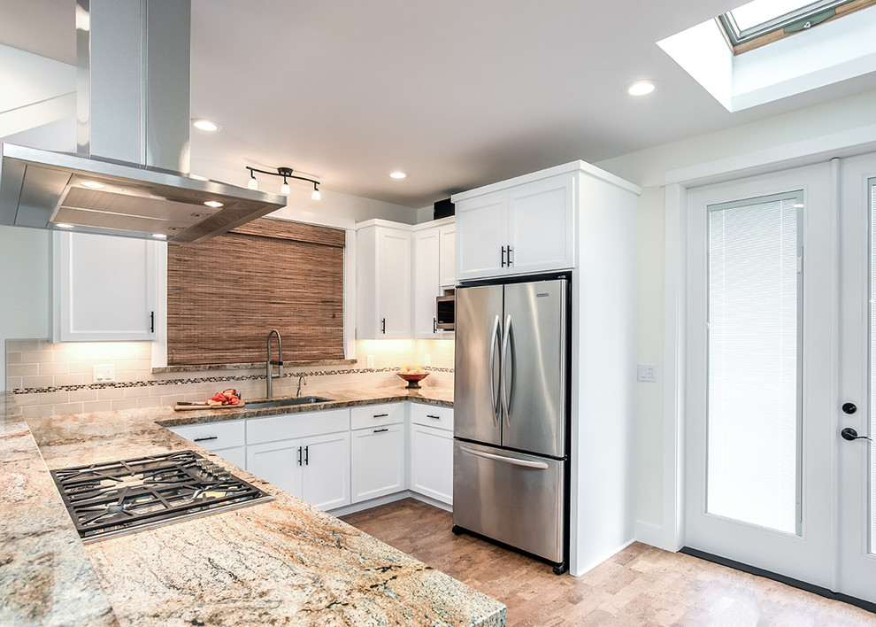 Inspiration for a mid-sized coastal l-shaped cork floor eat-in kitchen remodel in San Francisco with an undermount sink, shaker cabinets, white cabinets, granite countertops, beige backsplash, ceramic backsplash and stainless steel appliances