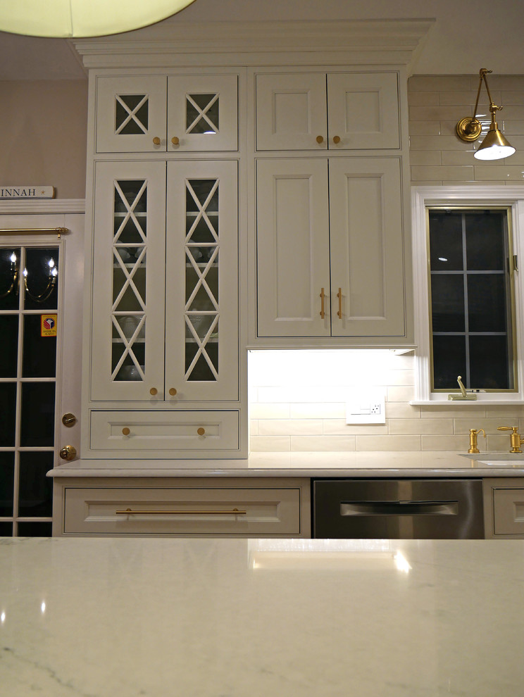 Inspiration for a large classic l-shaped kitchen pantry in Boston with a submerged sink, beaded cabinets, white cabinets, engineered stone countertops, white splashback, ceramic splashback, stainless steel appliances, medium hardwood flooring and an island.
