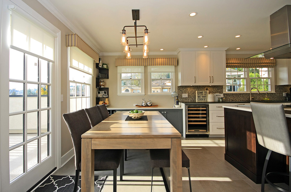 Example of a transitional l-shaped eat-in kitchen design in Vancouver with white cabinets, stainless steel appliances and an island