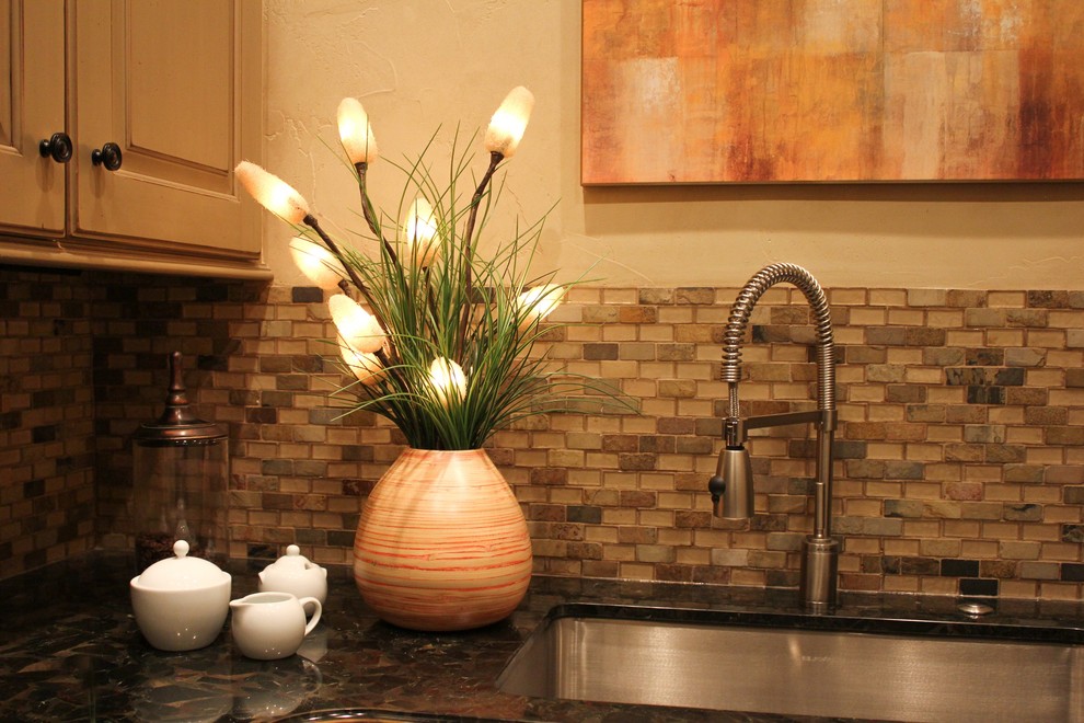 Example of an island style kitchen design in Denver