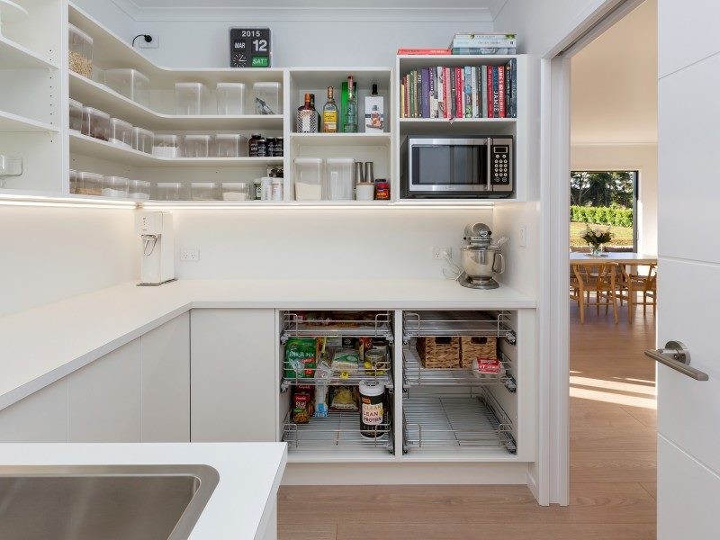 Inspiration for a contemporary galley kitchen in Other with flat-panel cabinets, laminate countertops and an island.