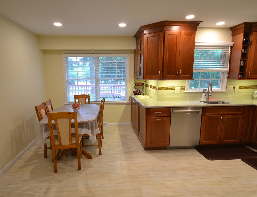 Bild på ett mellanstort vintage vit vitt kök, med en undermonterad diskho, luckor med infälld panel, skåp i mellenmörkt trä, granitbänkskiva, flerfärgad stänkskydd, stänkskydd i mosaik, rostfria vitvaror, klinkergolv i keramik och beiget golv